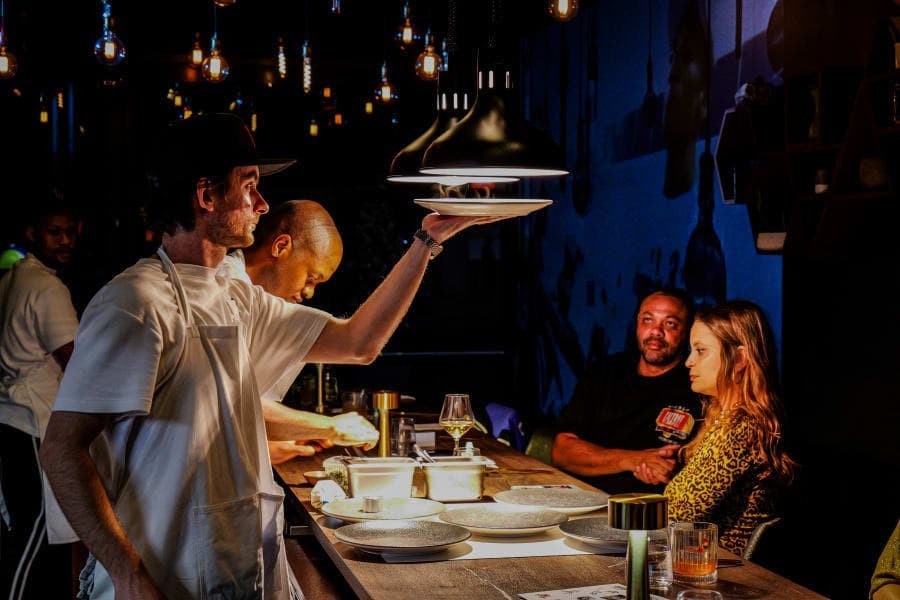 A chef serving guests in the Wiggle Room