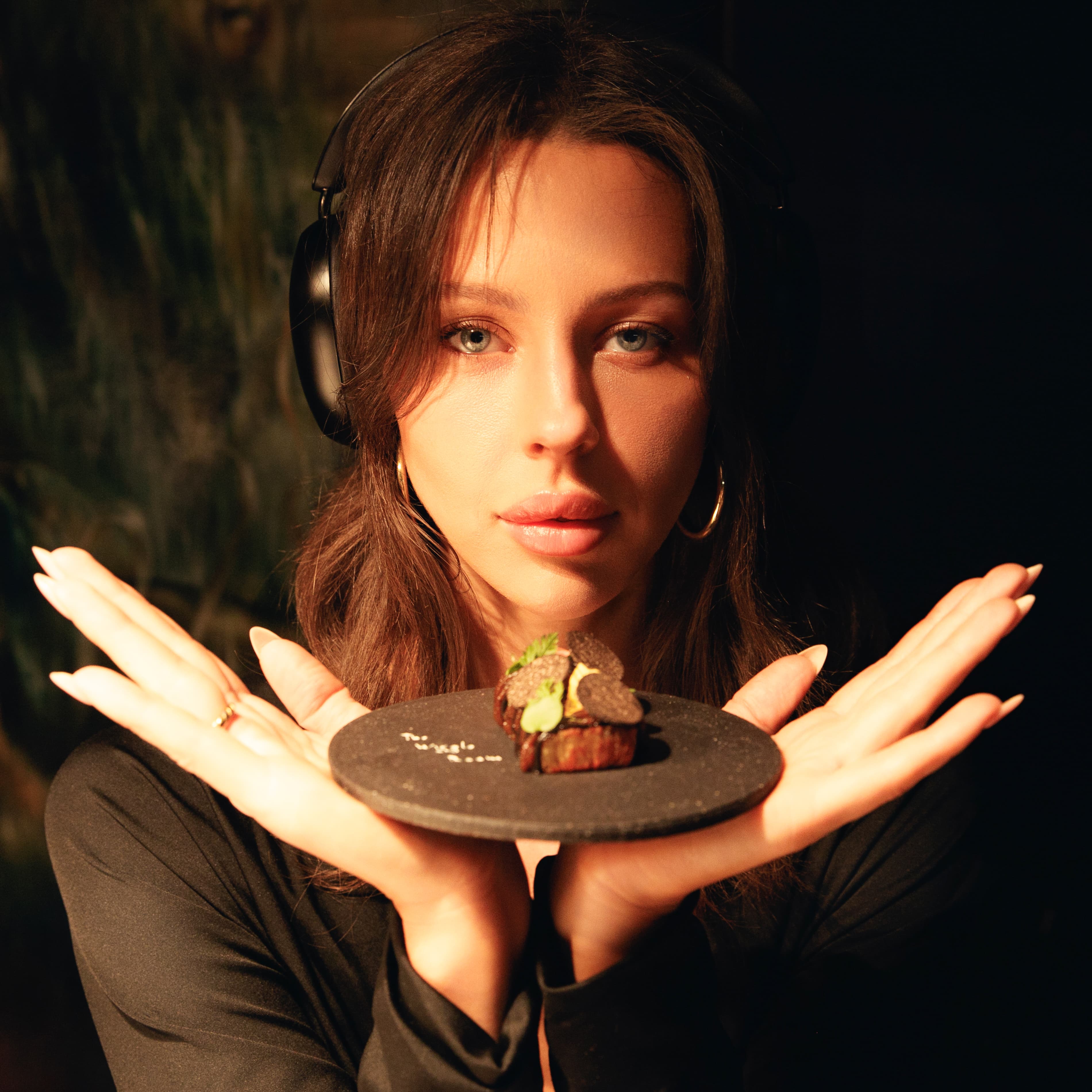 A plated Wiggle Room dish presented with headphones — food, music and place