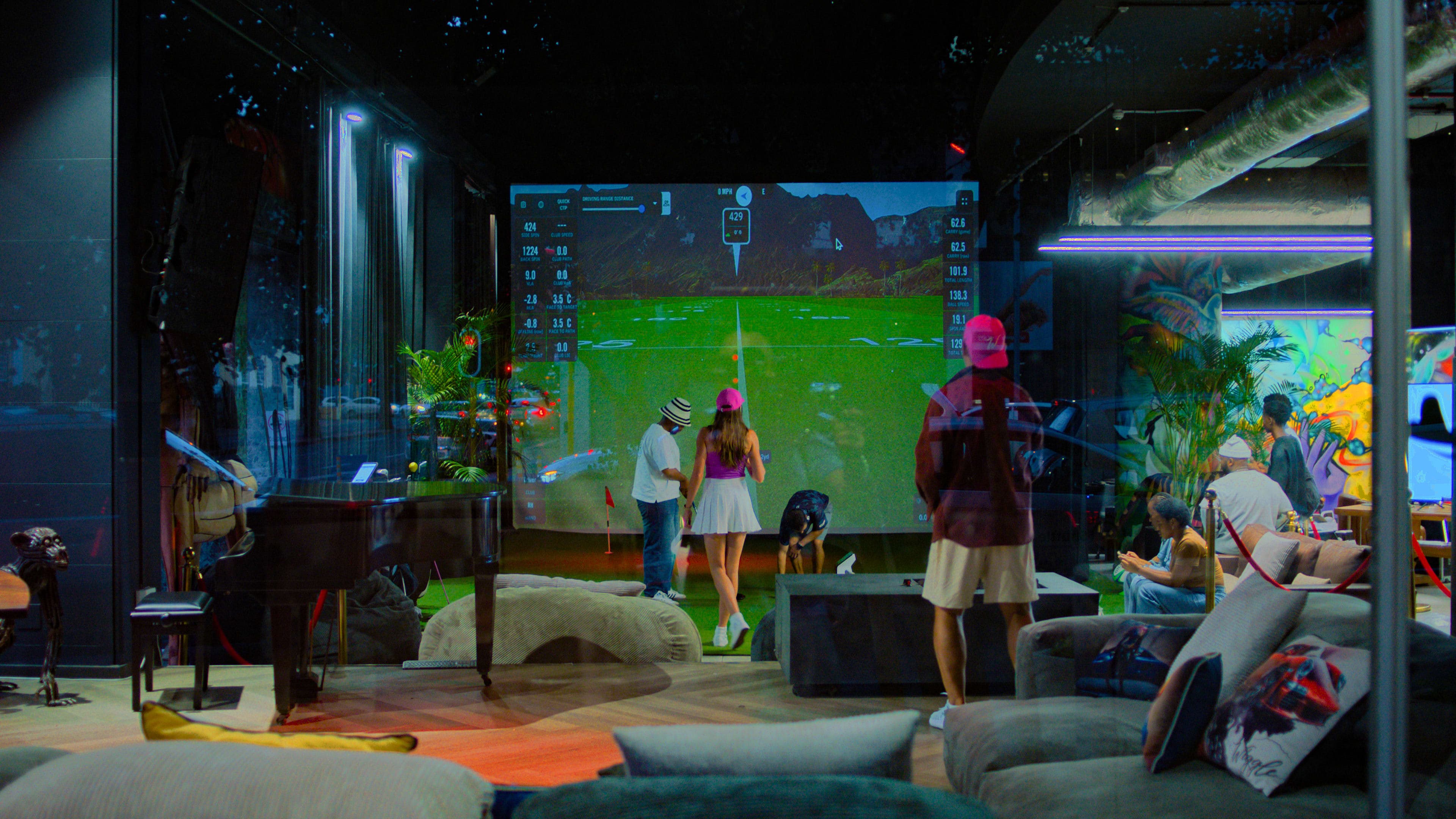 Golf simulator lounge with screen and seating